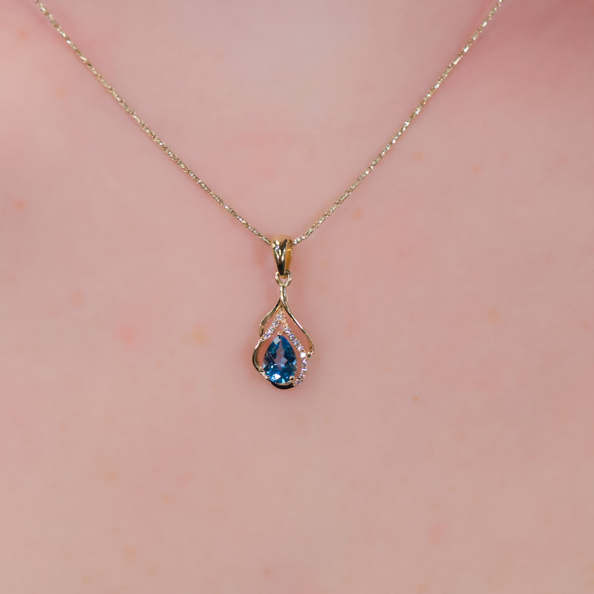 14kt Yellow Gold Swirl & .77 ct Blue Topaz with Diamond Accent Pendant