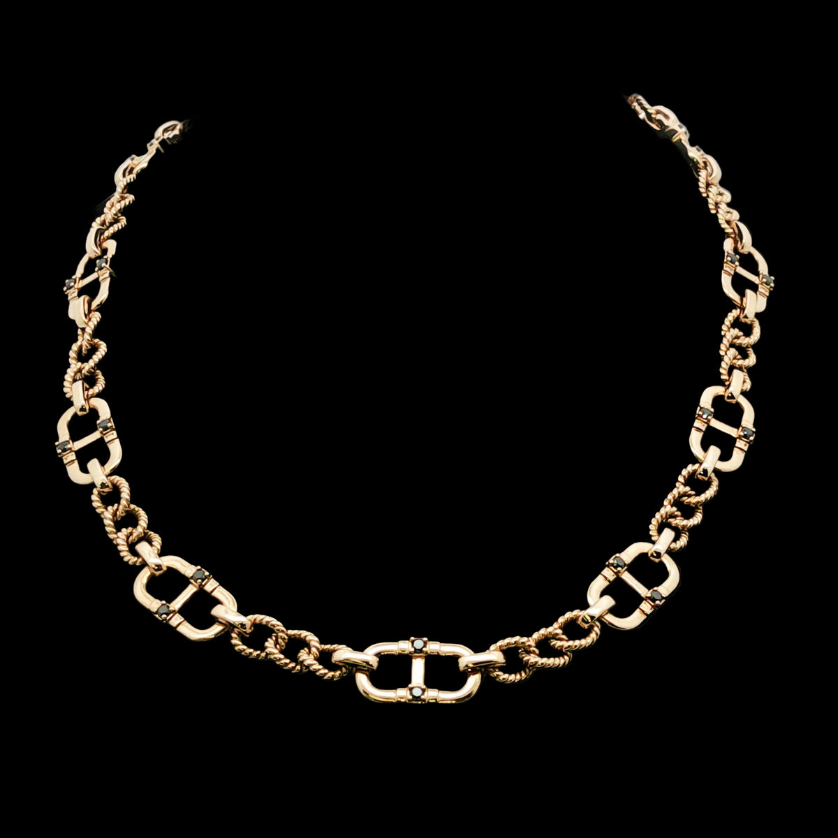 Mens black diamond and gold chain necklace on a black background